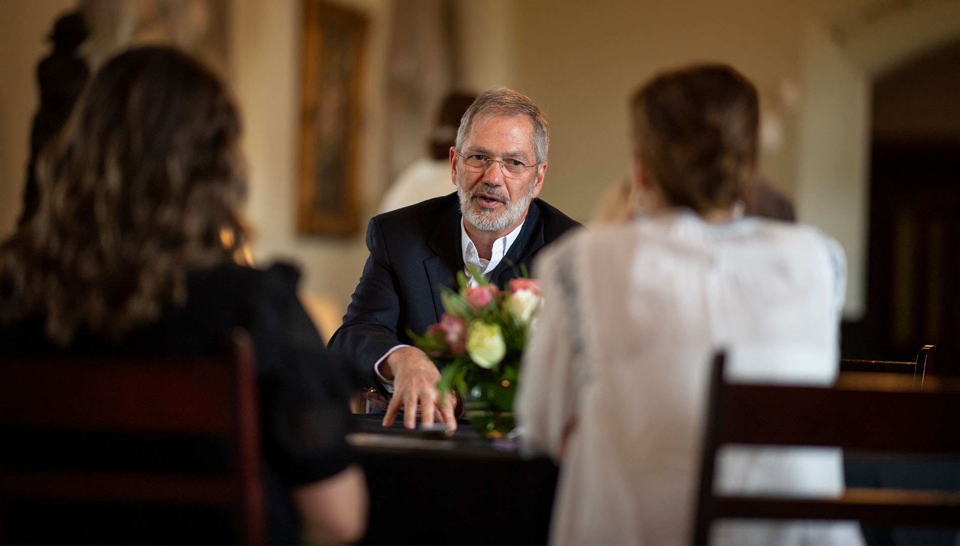 President Steve Briggs talking with two students