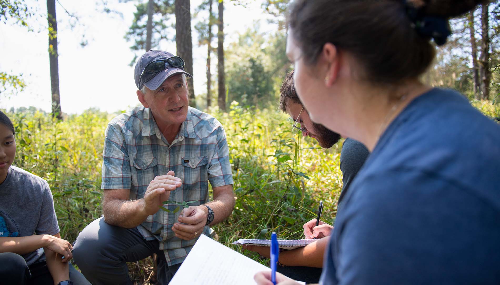 student and a professor in an outdoor ecology class